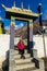 Muktinath - A woman sitting at the entrance to the temple