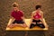 Muladhara swadhisthana manipula tantra yoga on the beach man and woman meditates sitting on the sand by the sea at