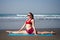 Muladhara swadhisthana manipula tantra yoga on the beach woman meditates sitting on the sand yoga mat by the sea at