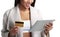 Mulatto black woman holding digital tablet computer and pay from gold credit card. Close-up view. on white.