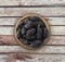 Mulberries in a wooden bowl with copy space for text. Ripe and tasty mulberry on a wooden background.