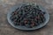 Mulberry in a bowl. Blackberry harvest in summer. Fruit food background.