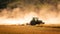 Mulching tractor after rapeseed harvest among the dust