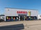 Mulheim-Karlich, Germany - May 18, 2023:: entrance and facade of the Haribo Outlet Store with the famous yellow Haribo bear.
