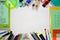 Mulitcoloured school items frame background