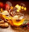 Mulled cider with slice apples, cinnamon, cloves, anise stars and citrus fruits in glass cups on a wooden rustic table, close-up.