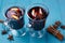 Mulled wine, cinnamon sticks and anise on blue background. Hot d