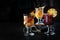 Mulled wine in glass glasses. Three types of mulled wine. Assorted drinks on a dark background. A hot traditional