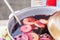 Mulled wine prepared in iron pot at city street fair. Traditional christmas and new year alcohol drink - hot wine. Stall with