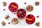Mulled wine in small glasses with cranberries, anise and oranges. White background, top view