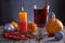 Mulled wine vith candle, oranges, spices and christmas decoration