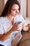 Mulling over her day with a fresh cup of coffee. A young woman looking thoughtful while drinking her morning coffee.