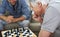 Mulling over his move. a father and son playing a game of chess together at home.