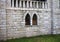 A mullioned window with pointed arches in a medieval stone building Marche, Italy