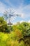 Multi-bladed wind pump between the shrubs