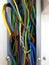 Multi color electric cords in metal track.