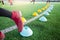 Multi color marker cones on green artificial turf with blurry soccer player  moving speed test and Jogging and jump between it.