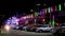 Multi color neon light and car in night market fair parking area