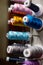 Multi color small spools of sewing thread stacks on large cylinder display