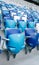 Multi-colored armchairs with numbers on a football stadium. Blue and white color.