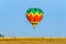 Multi-colored balloon with a basket, a flame of fire takes off i