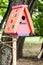 multi-colored birdhouse on the tree