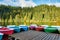 Multi-colored boats at the pier on Lake Lacu Rosu, Romania. Autumn landscape of mountain lake