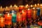 Multi colored candles burning in the evening. Oriental feel.