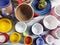 Multi-colored caps and  bowls on wooden background. Pottery Shop. Designer ceramic dishes. Ceramic tableware top view. Modern