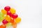 Multi-colored caramel candies on a white background. Place for text. Yellow, red, green sweets