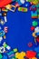 Multi-colored children`s development games designer toys on a blue background