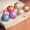 Multi colored christmas balls with red and white ribbon decoration in white snow in a tray