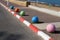 Multi-colored concrete balls lie on the sidewalk in the city
