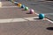 Multi-colored concrete balls lie on the sidewalk in the city