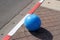 Multi-colored concrete balls lie on the sidewalk in the city