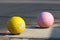 Multi-colored concrete balls lie on the sidewalk in the city