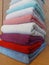 Multi-colored cotton terry towels are stacked