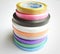 Multi colored curling ribbon arranged in vertical shape beautifully in white chart as backgrounds