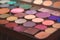Multi-colored eye and makeup palette shades, women`s cosmetics close-up