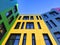 Multi-colored facades of the school with black window frames.