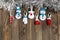 Multi-colored felt Christmas toys and silver tinsel on a wooden background