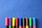 Multi colored felt pens with wrong color caps at blue background