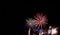 Multi-colored firework starburst fireworks against a black background