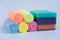 Multi-colored foam sponges for washing dishes and microfiber cloths. All multicolored items on a white background