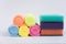 Multi-colored foam sponges for washing dishes and microfiber cloths. All multicolored items on a white background