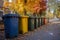 Multi-colored garbage containers on the city street, recycling and separate waste collection concept, AI Generated