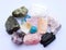 Multi-colored gemstones, raw minerals. Rose quartz, turquoise, citrine, aquamarines, fluorite, red gypsum, black tourmaline