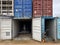 Multi-colored iron industrial sea containers for international transportation of goods according to the logistic rules of