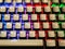 Multi-colored keyboard. mechanical keys. Multi-colored professional gaming mechanical rgb keyboard on the table background