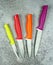 Multi-colored kitchen knives: red, burgundy, orange, yellow